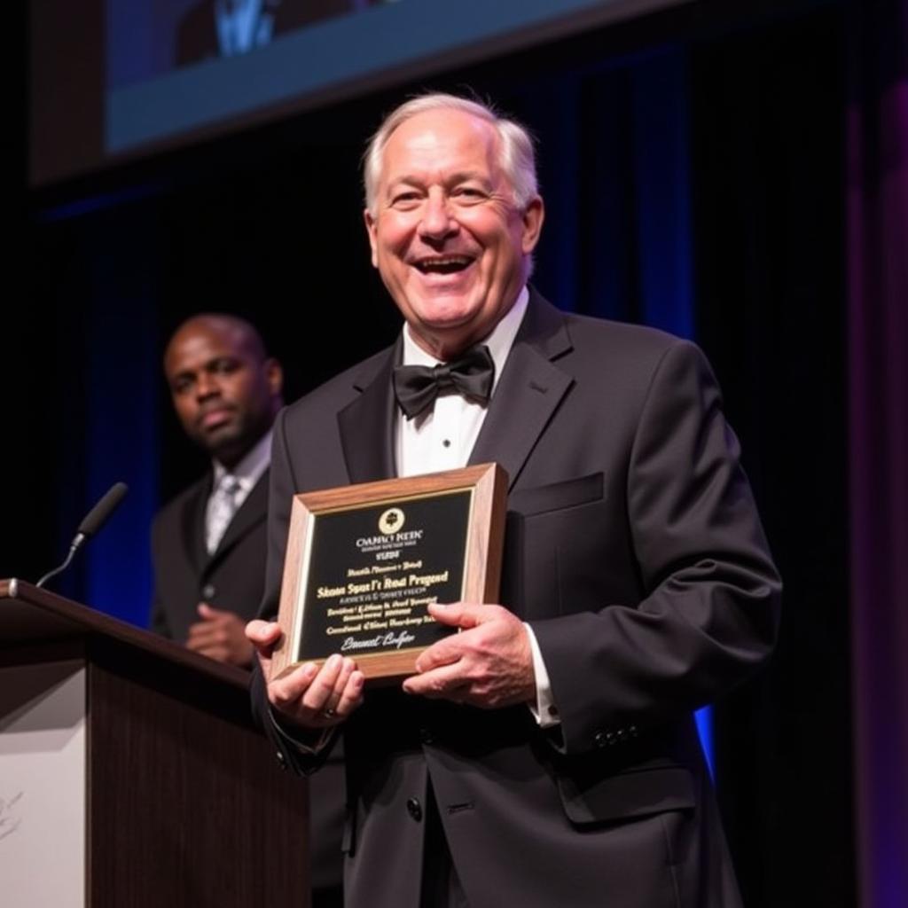 John Parkinson being honored with a prestigious award for his contribution to football