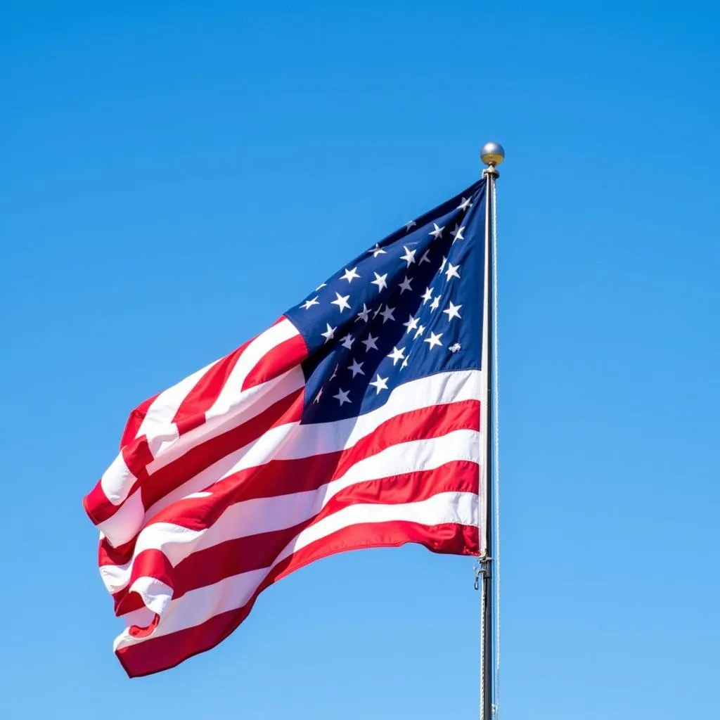 American flag waving against blue sky