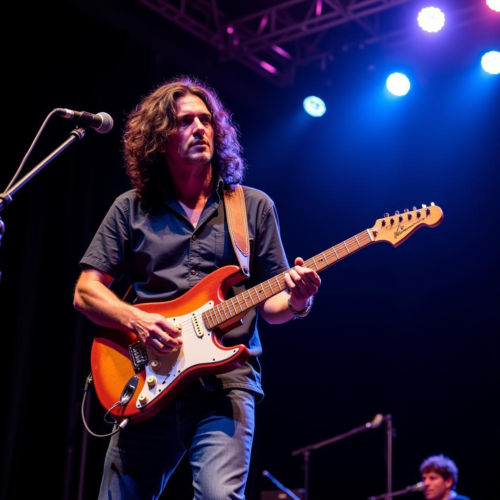 A musician captivating the audience with a Jerry Garcia replica guitar