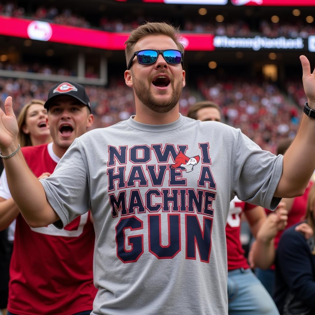 Fan wearing a "Now I have a machine gun" shirt at a stadium